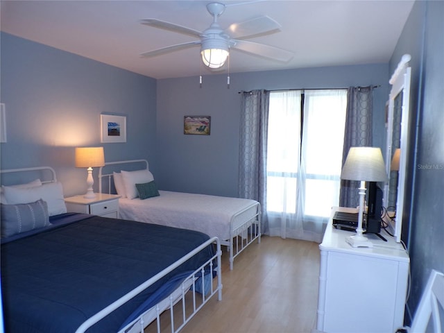 1801 Gulf Dr N Unit 207, Bradenton Beach, FL 34217 - bedroom with light wood-style flooring and a ceiling fan