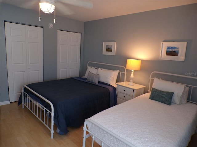 1801 Gulf Dr N Unit 207, Bradenton Beach, FL 34217 - bedroom featuring light wood-style flooring, multiple closets, and ceiling fan