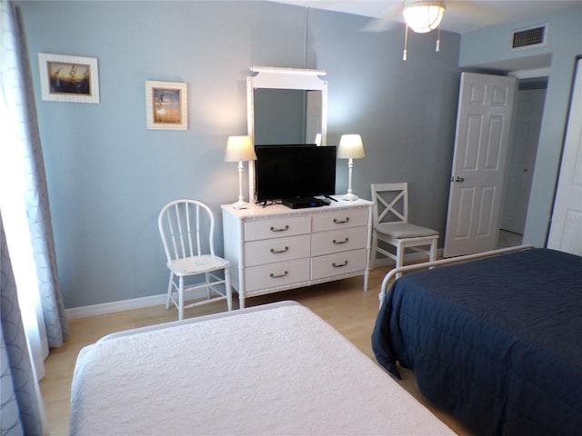 1801 Gulf Dr N Unit 207, Bradenton Beach, FL 34217 - bedroom with light wood-style flooring and ceiling fan