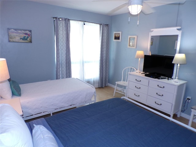 1801 Gulf Dr N Unit 207, Bradenton Beach, FL 34217 - bedroom with light wood-style floors and ceiling fan