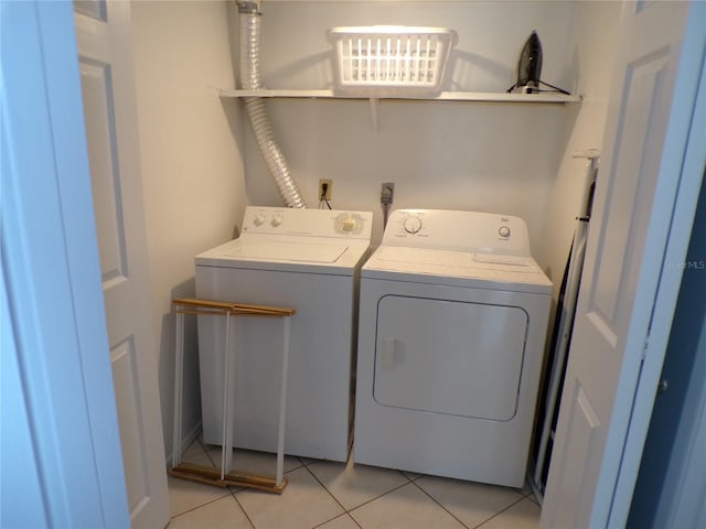 1801 Gulf Dr N Unit 207, Bradenton Beach, FL 34217 - washroom with washer and clothes dryer and light tile patterned floors