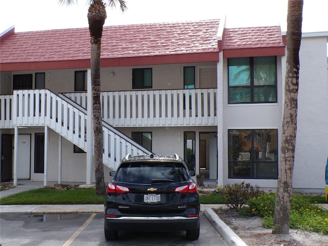 1801 Gulf Dr N Unit 207, Bradenton Beach, FL 34217 - view of building exterior with uncovered parking and stairway