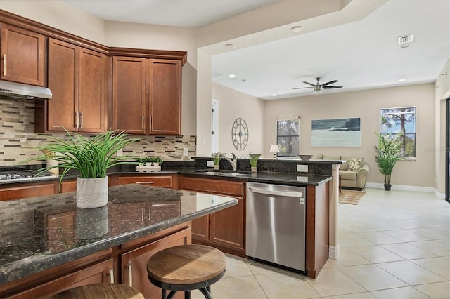 13503 22nd Ct E, Parrish, FL 34219 - kitchen with stainless steel appliances, light tile patterned floors, under cabinet range hood, open floor plan, and tasteful backsplash
