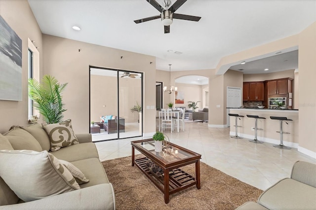 13503 22nd Ct E, Parrish, FL 34219 - living area featuring ceiling fan, light tile patterned floors, arched walkways, a chandelier, and recessed lighting