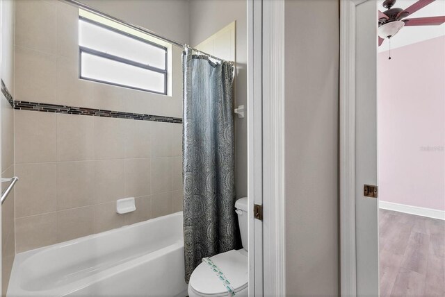 13503 22nd Ct E, Parrish, FL 34219 - bathroom featuring shower / bath combo with shower curtain, a ceiling fan, and wood finished floors