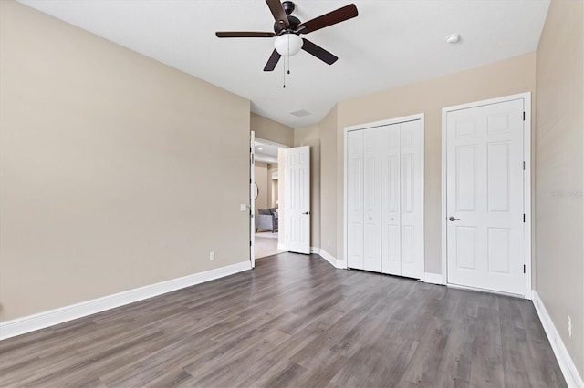 13503 22nd Ct E, Parrish, FL 34219 - unfurnished bedroom with dark wood-type flooring, a closet, and ceiling fan