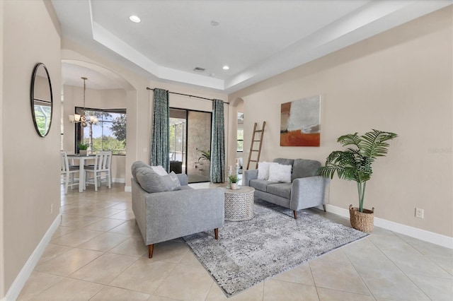13503 22nd Ct E, Parrish, FL 34219 - living area featuring arched walkways, a chandelier, light tile patterned floors, a tray ceiling, and recessed lighting