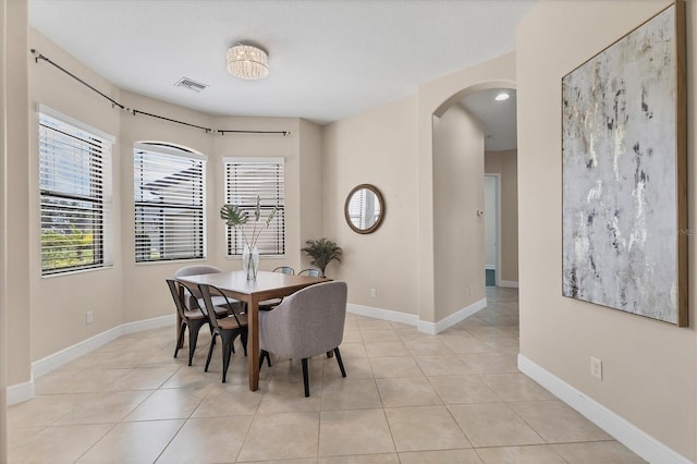 13503 22nd Ct E, Parrish, FL 34219 - dining space featuring arched walkways, healthy amount of natural light, and light tile patterned flooring