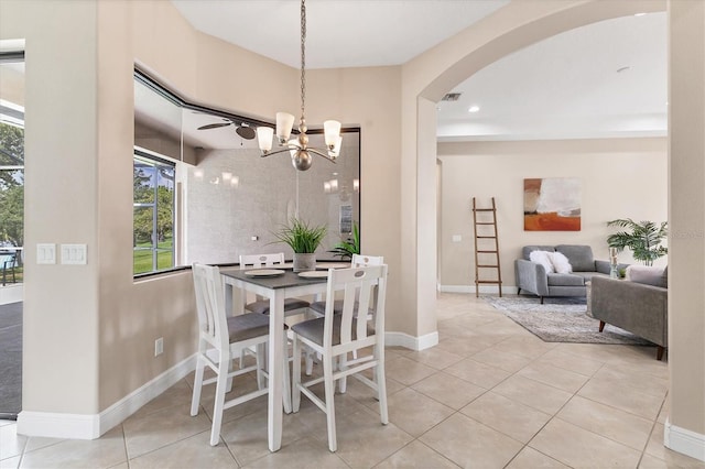 13503 22nd Ct E, Parrish, FL 34219 - dining space featuring arched walkways, a chandelier, light tile patterned flooring, and recessed lighting