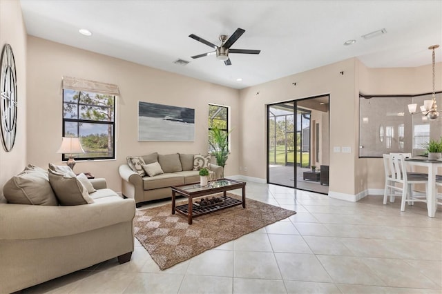 13503 22nd Ct E, Parrish, FL 34219 - living room with healthy amount of natural light, light tile patterned flooring, ceiling fan, a chandelier, and recessed lighting