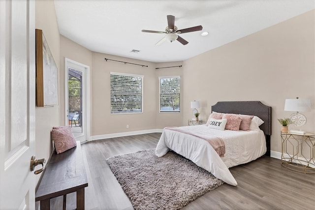 13503 22nd Ct E, Parrish, FL 34219 - bedroom with multiple windows, wood finished floors, access to exterior, and recessed lighting