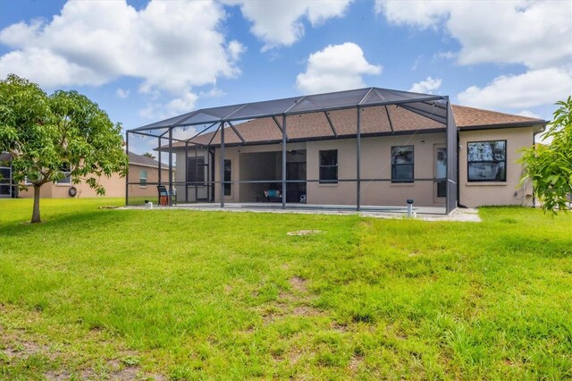 13503 22nd Ct E, Parrish, FL 34219 - rear view of property featuring a lawn, stucco siding, and a lanai