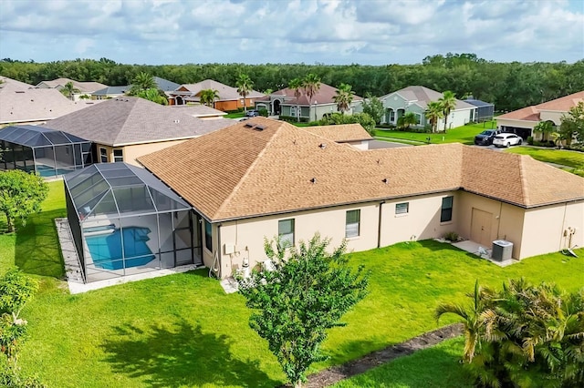 13503 22nd Ct E, Parrish, FL 34219 - rear view of house featuring a residential view, an outdoor pool, stucco siding, and a lawn