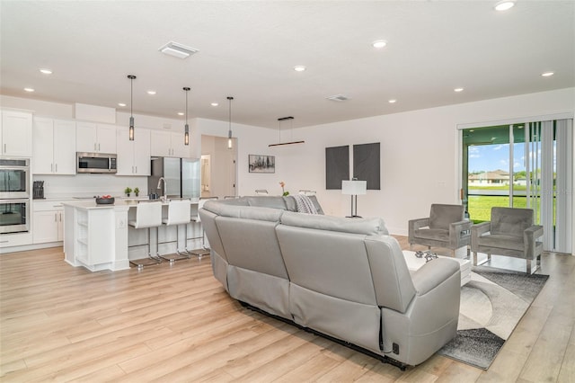 2108 Citrus Breeze Dr, Bradenton, FL 34208 - living room with light wood-style floors and recessed lighting