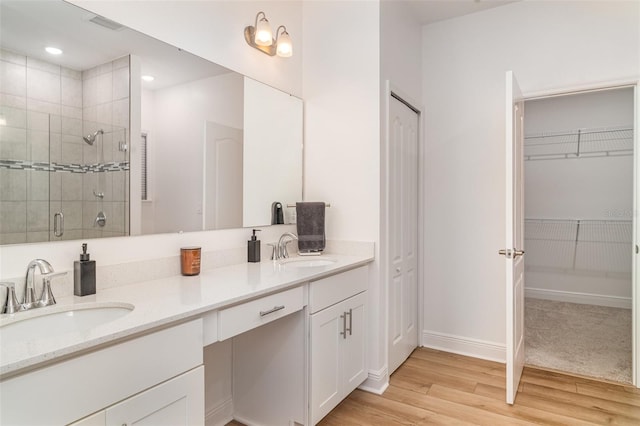 2108 Citrus Breeze Dr, Bradenton, FL 34208 - full bathroom featuring double vanity, a shower stall, wood finished floors, a spacious closet, and recessed lighting