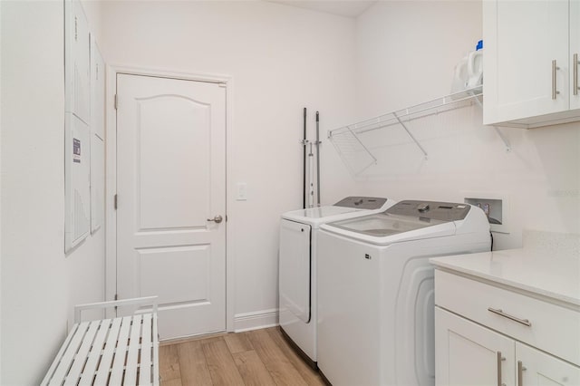 2108 Citrus Breeze Dr, Bradenton, FL 34208 - laundry area featuring independent washer and dryer, cabinet space, and light wood-style floors