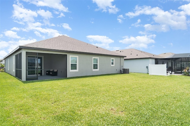 2108 Citrus Breeze Dr, Bradenton, FL 34208 - rear view of house featuring a sunroom, stucco siding, and a yard