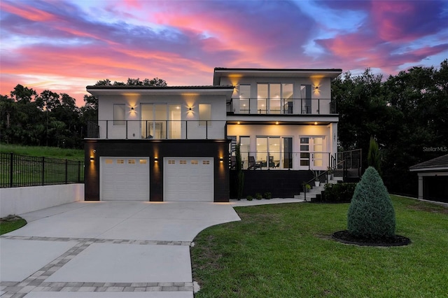 1841 Moorings Ct, Clermont, FL 34711 - modern home featuring a balcony, stucco siding, concrete driveway, a garage, and stairway