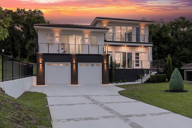 1841 Moorings Ct, Clermont, FL 34711 - contemporary house with a balcony, stucco siding, an attached garage, and a lawn