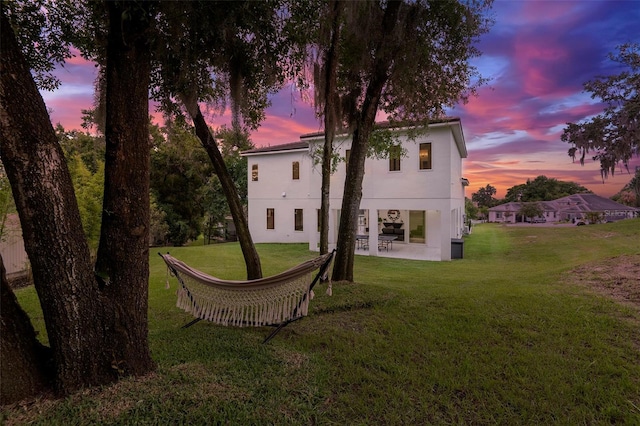 1841 Moorings Ct, Clermont, FL 34711 - back of house featuring stucco siding, a yard, and a patio area