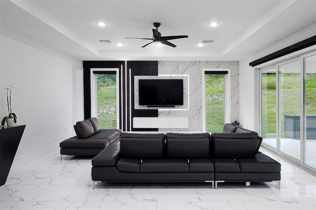 1841 Moorings Ct, Clermont, FL 34711 - living room featuring a raised ceiling, a ceiling fan, light marble finish floors, and recessed lighting
