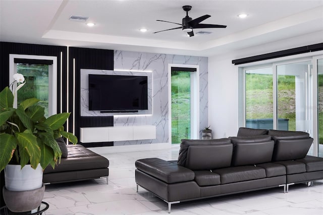 1841 Moorings Ct, Clermont, FL 34711 - living room featuring a tray ceiling, marble finish flooring, ceiling fan, and recessed lighting