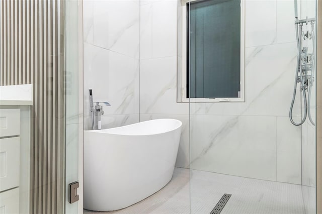 1841 Moorings Ct, Clermont, FL 34711 - bathroom featuring tile walls, a freestanding bath, tiled shower, and tile patterned floors