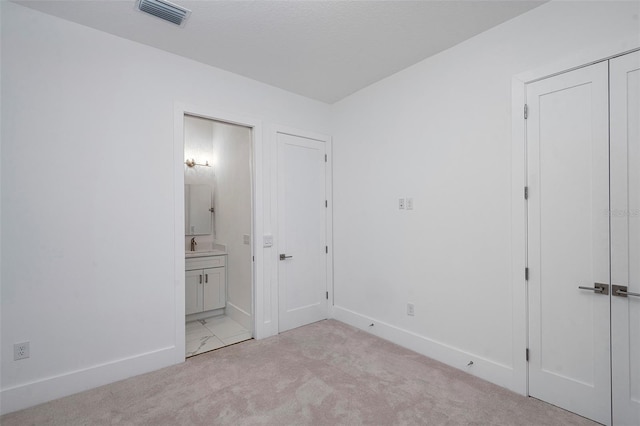 1841 Moorings Ct, Clermont, FL 34711 - unfurnished bedroom featuring ensuite bathroom and light colored carpet