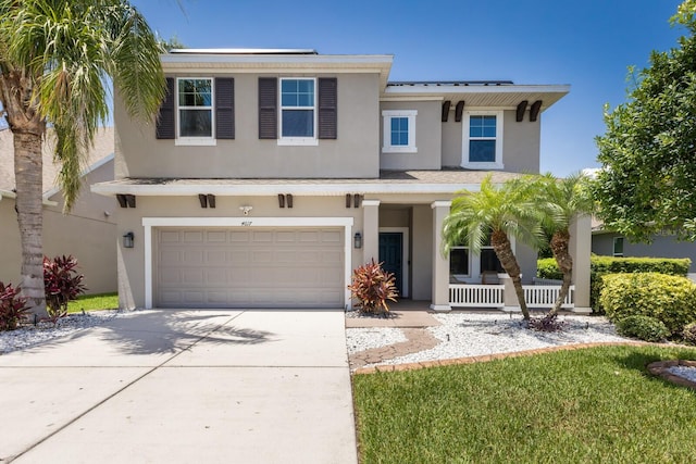 4617 Garden Arbor Way, Bradenton, FL 34203 - view of front of house featuring a porch, stucco siding, a garage, and concrete driveway