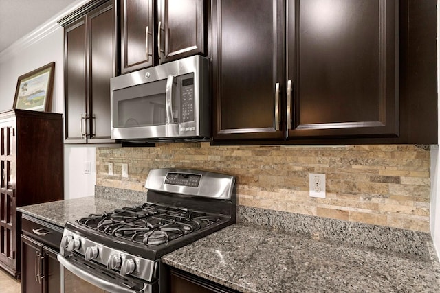 4617 Garden Arbor Way, Bradenton, FL 34203 - kitchen with stainless steel appliances, dark stone counters, dark brown cabinetry, decorative backsplash, and crown molding