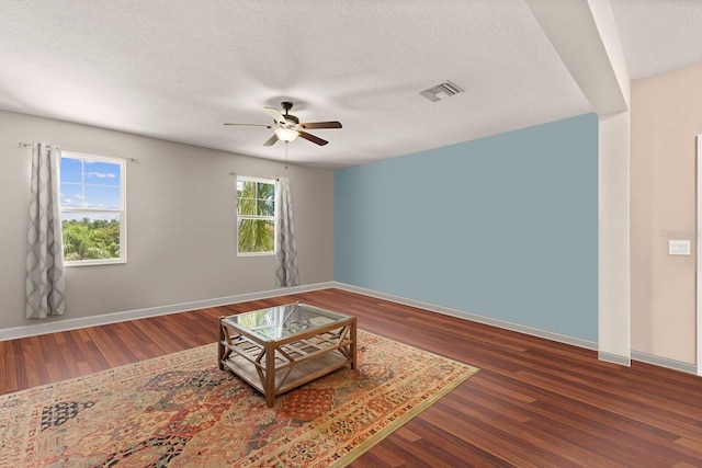 4617 Garden Arbor Way, Bradenton, FL 34203 - living room with ceiling fan, wood finished floors, baseboards, and a textured ceiling