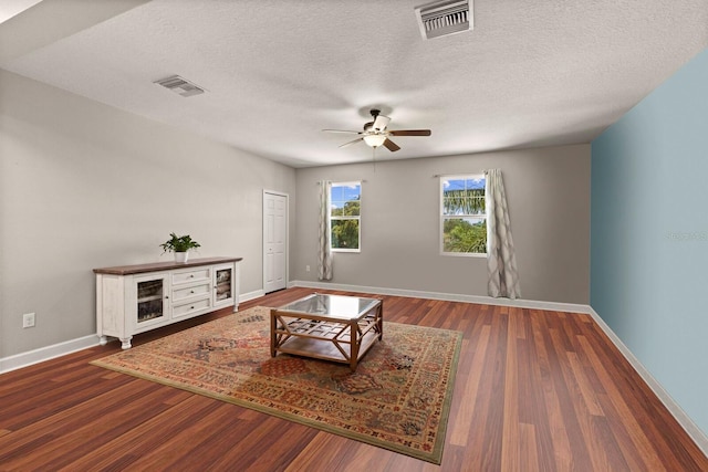 4617 Garden Arbor Way, Bradenton, FL 34203 - unfurnished living room with ceiling fan, baseboards, wood finished floors, and a textured ceiling