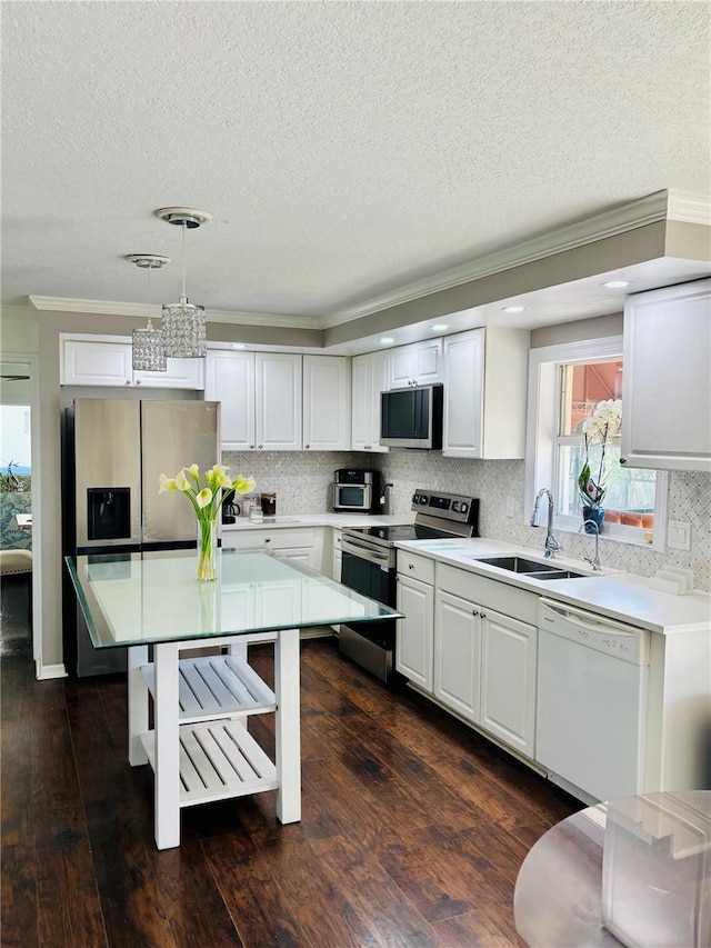 4907 Kilty Ct E, Bradenton, FL 34203 - kitchen featuring stainless steel appliances, crown molding, a textured ceiling, light countertops, and tasteful backsplash