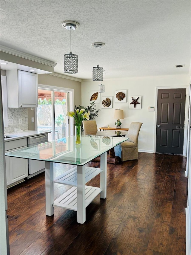 4907 Kilty Ct E, Bradenton, FL 34203 - dining area with dark wood-style floors, ornamental molding, and a textured ceiling
