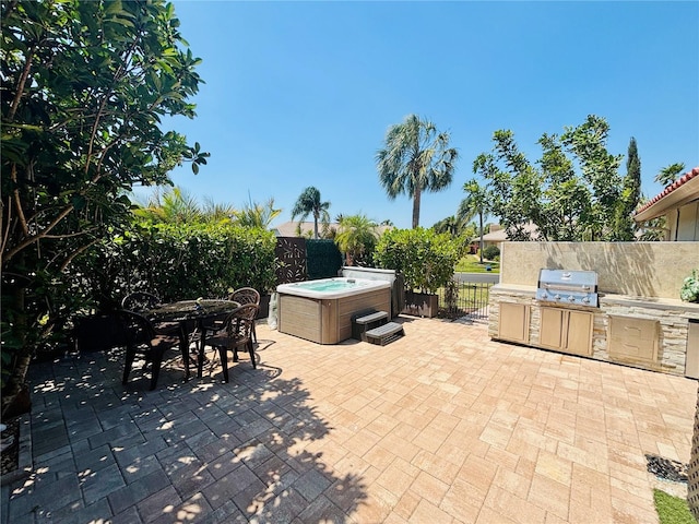 4907 Kilty Ct E, Bradenton, FL 34203 - fenced backyard with area for grilling, a patio, a hot tub, and outdoor dining space