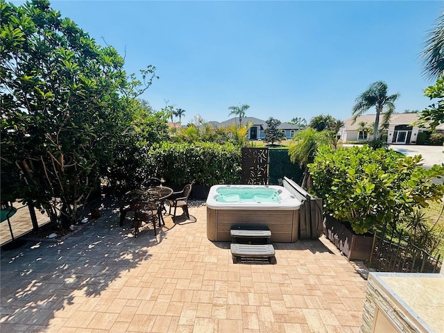 4907 Kilty Ct E, Bradenton, FL 34203 - view of patio with a hot tub, outdoor dining area, and a residential view