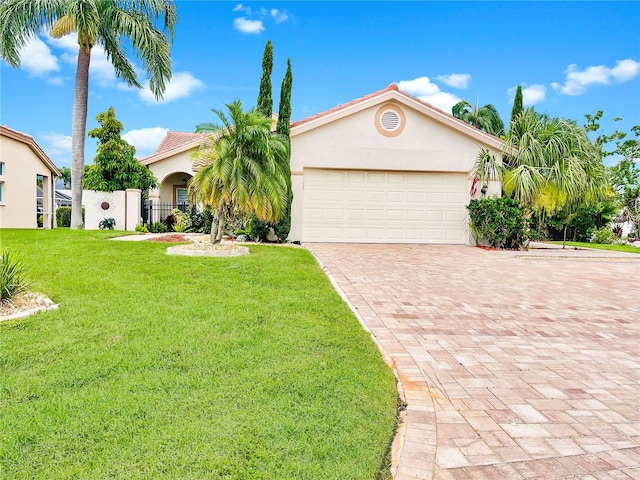 4907 Kilty Ct E, Bradenton, FL 34203 - mediterranean / spanish house with stucco siding, decorative driveway, a front yard, and a garage