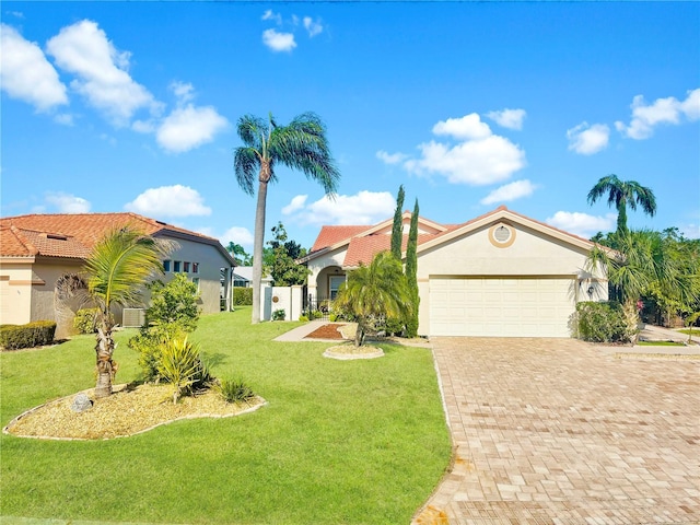 4907 Kilty Ct E, Bradenton, FL 34203 - view of front facade with an attached garage, stucco siding, decorative driveway, and a front yard