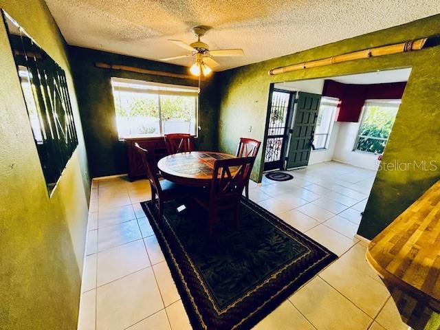 2607 29th Ave W, Bradenton, FL 34205 - tiled dining area featuring a textured ceiling and a ceiling fan