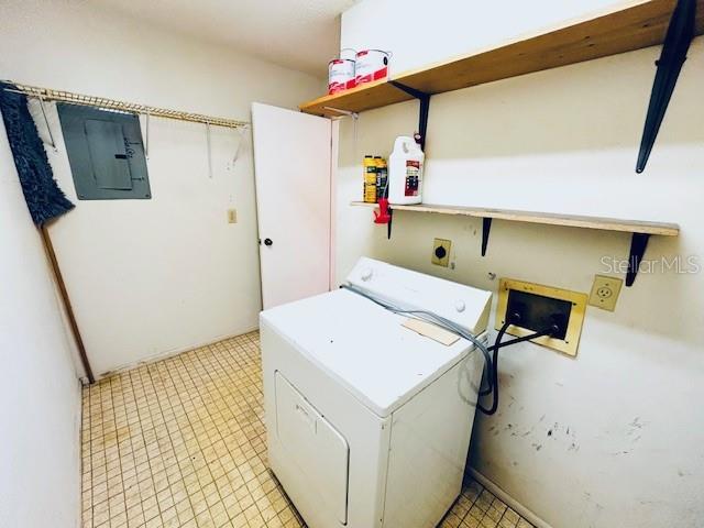 2607 29th Ave W, Bradenton, FL 34205 - washroom featuring washer / dryer, electric panel, and light floors