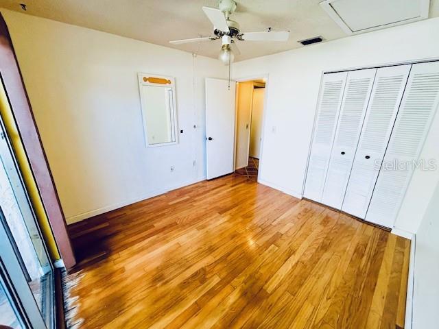 2607 29th Ave W, Bradenton, FL 34205 - unfurnished bedroom with light wood-style floors, a closet, and ceiling fan