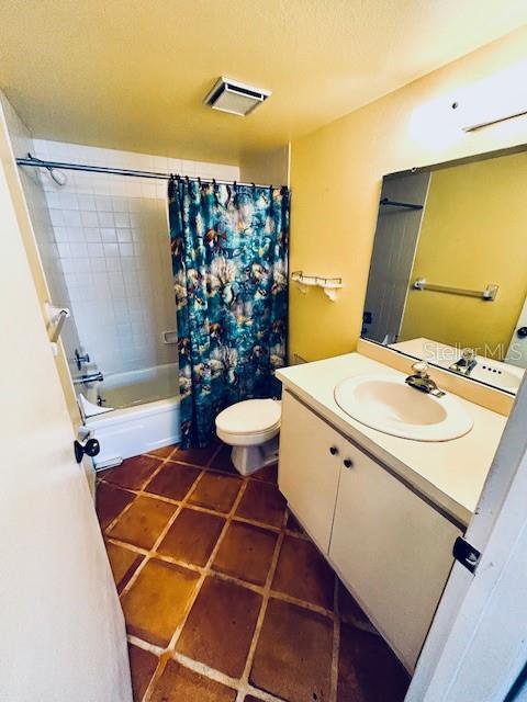 2607 29th Ave W, Bradenton, FL 34205 - full bathroom featuring vanity, shower / tub combo, toilet, and tile patterned floors