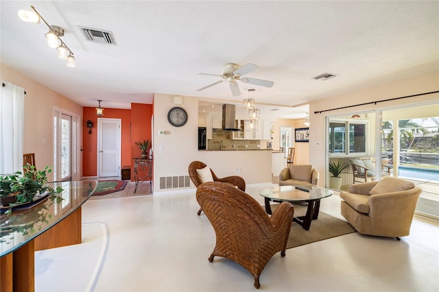 2807 Coral Way, Punta Gorda, FL 33950 - living room with finished concrete flooring, a ceiling fan, and plenty of natural light