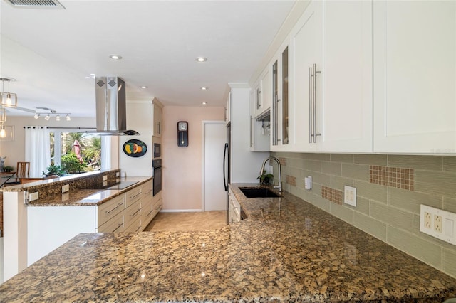 2807 Coral Way, Punta Gorda, FL 33950 - kitchen with a sink, island exhaust hood, black appliances, a peninsula, and dark stone counters