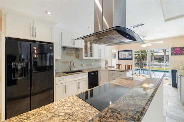 2807 Coral Way, Punta Gorda, FL 33950 - kitchen featuring black appliances, a sink, island range hood, white cabinets, and backsplash