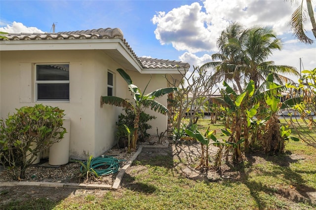 2807 Coral Way, Punta Gorda, FL 33950 - view of side of home featuring a tiled roof and stucco siding