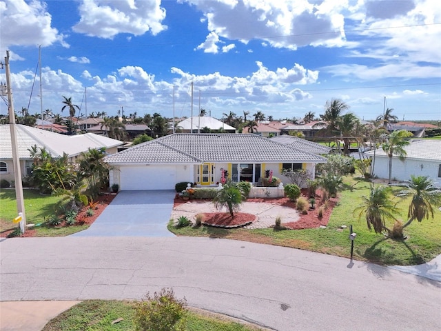2807 Coral Way, Punta Gorda, FL 33950 - ranch-style home featuring concrete driveway, a tiled roof, an attached garage, a front yard, and a residential view