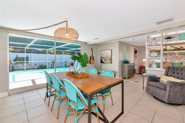 5948 Mirror Lake Rd, Sarasota, FL 34238 - dining room with light tile patterned floors and a sunroom