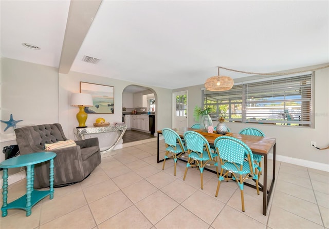 5948 Mirror Lake Rd, Sarasota, FL 34238 - dining area featuring arched walkways and light tile patterned flooring