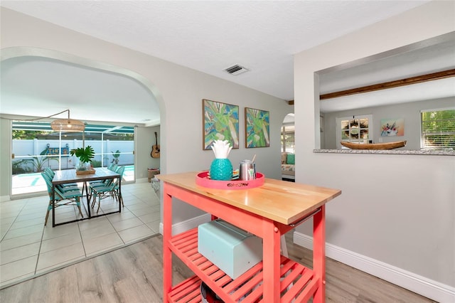 5948 Mirror Lake Rd, Sarasota, FL 34238 - dining area with arched walkways and light wood-type flooring